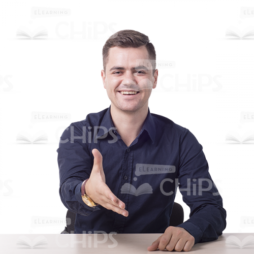Pleased Man Sitting And Making Greeting Gesture -0