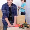 Young Man Stands Next To Cardbox Stock Photo