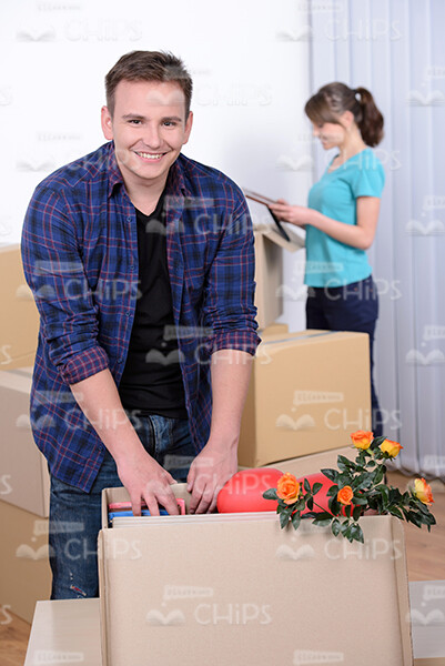 Young Man Stands Next To Cardbox Stock Photo