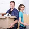 Young Man and His Wife Holding Cardboxes Stock Photo