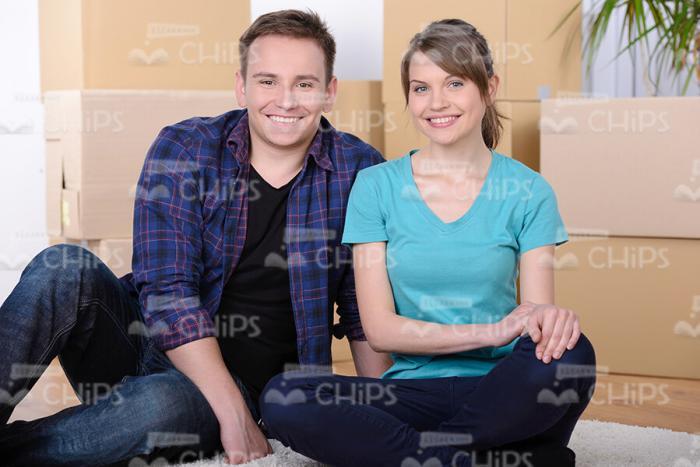 Young Couple Sitting on Floor Stock Photo