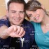 Married Couple Showing Keys to New Apartment Stock Photo