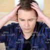 Close Up Stock Photo of Troubled Young Man with Hands on His Head