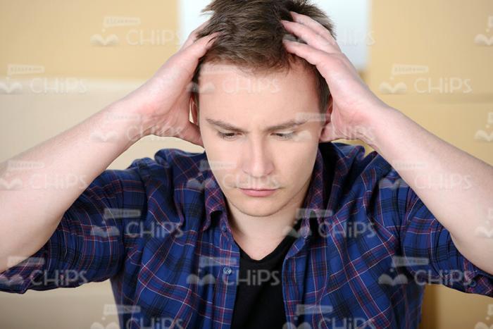 Close Up Stock Photo of Troubled Young Man with Hands on His Head