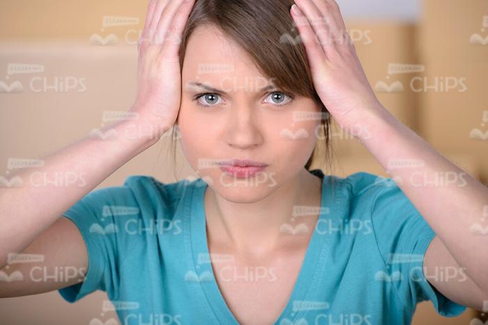 Perplexed Woman With Hands On Her Head Stock Photo