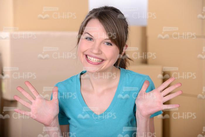 Excited Woman Spreads Palms To The Sides Stock Photo