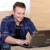 Happy Man Typing on Laptop Stock Photo