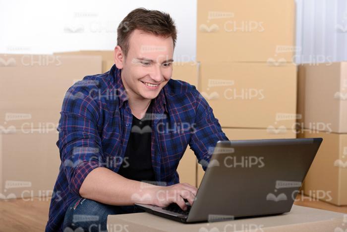 Happy Man Typing on Laptop Stock Photo