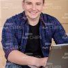 Smiling Young Man With Laptop Stock Photo