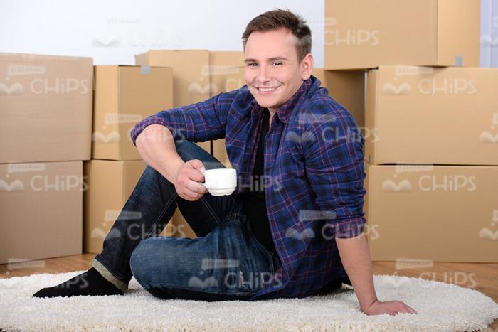 Young Man Holding Small White Cup Stock Photo