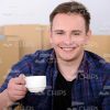 Happy Man Holds Coffee Cup Stock Photo