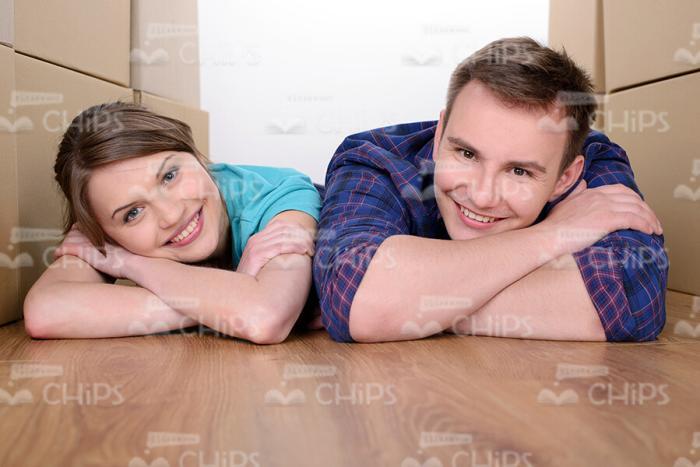 Happy Married Couple Lying On Floor Stock Photo