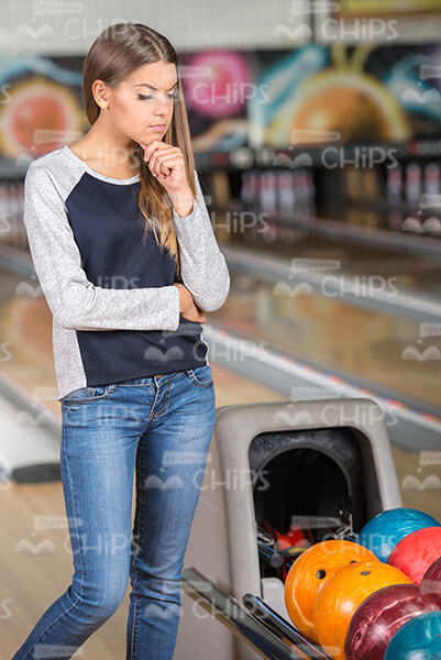 Woman Looking For Bowling Ball Stock Photo