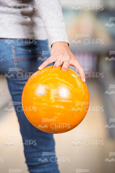 Yellow Bowling Ball in Woman's Hand Stock Photo