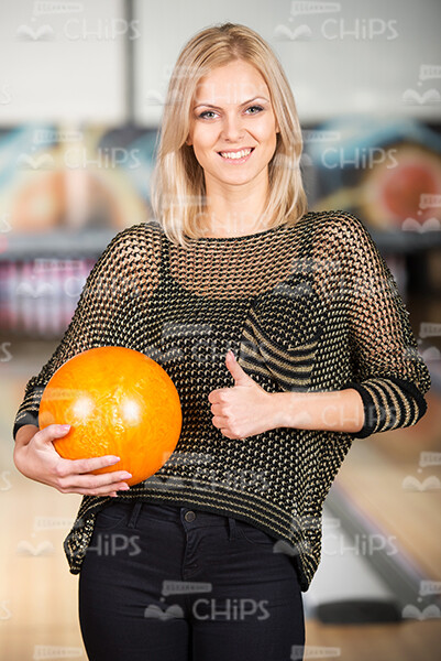 Pretty Woman At Bowling Alley Shows Thumb Up Stock Photo