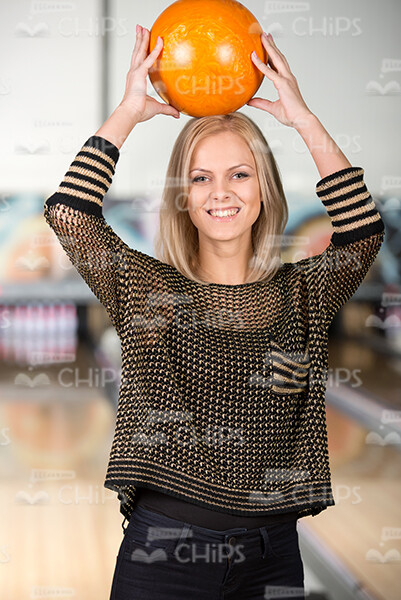 Woman Holding Bowling Ball On Head Stock Photo