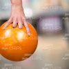 Yellow Bowling Ball In Someone's Hand Stock Photo