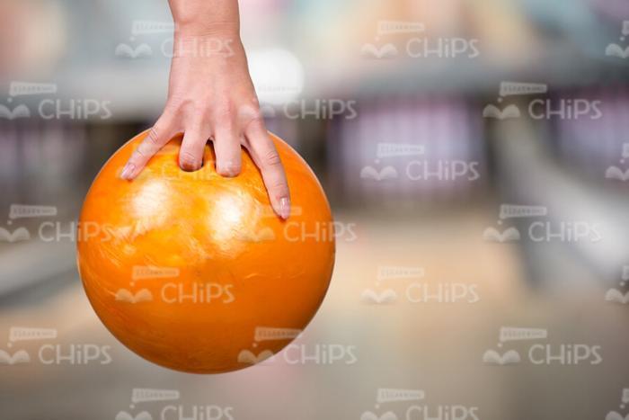 Yellow Bowling Ball In Someone's Hand Stock Photo