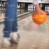 Woman Going To Throw Orange Bowling Ball Stock Photo
