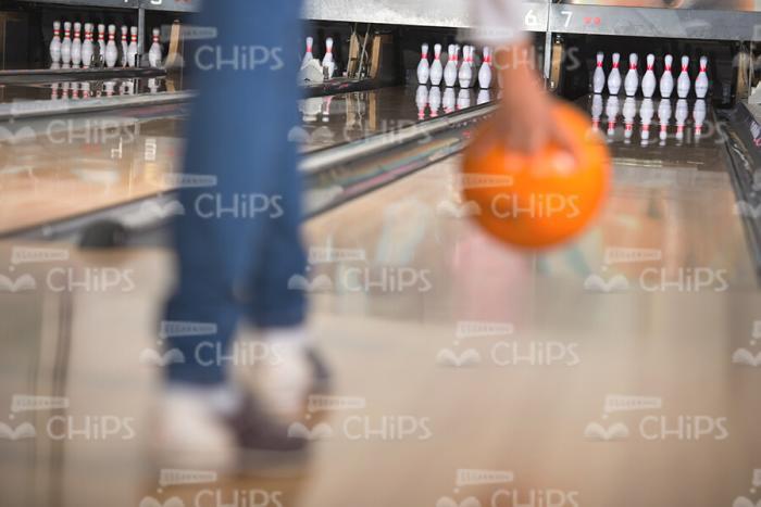 Woman Going To Throw Orange Bowling Ball Stock Photo