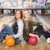 Two Women Are Sitting Back To Back Stock Photo