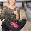 Glad Woman Sits On Bowling Alley Floor Stock Photo