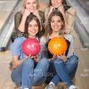 Handsome Ladies Sitting On Bowling Alley Floor Stock Photo