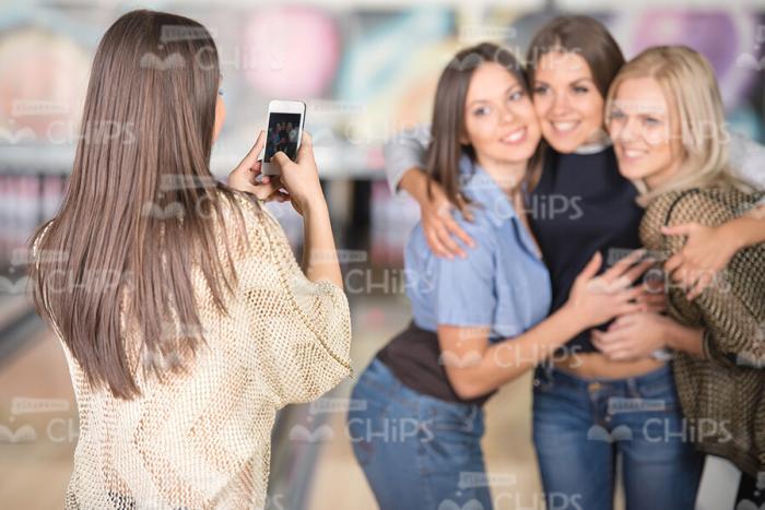 Woman Taking Photo Of Her Friends Stock Photo