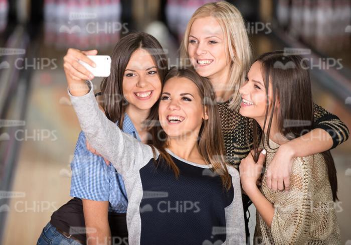 Female Friends Taking Picture At Bowling Stock Photo