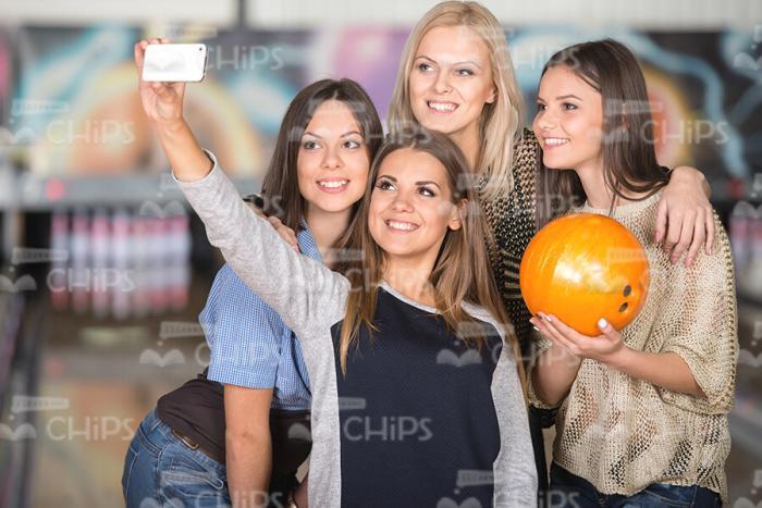 Young Women Taking Selfie At Bowling Alley Stock Photo