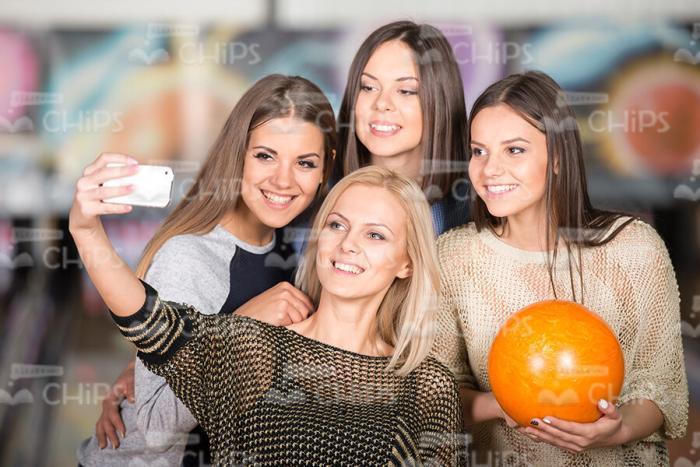 Girls With Bowling Ball Are Making Photo On Mobile Phone Stock Photo