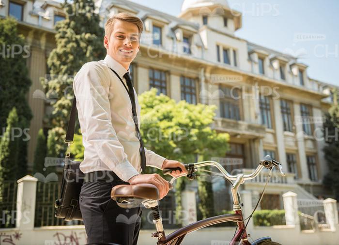Happy Young Man Standing Straight And Holding Bike Stock Photo