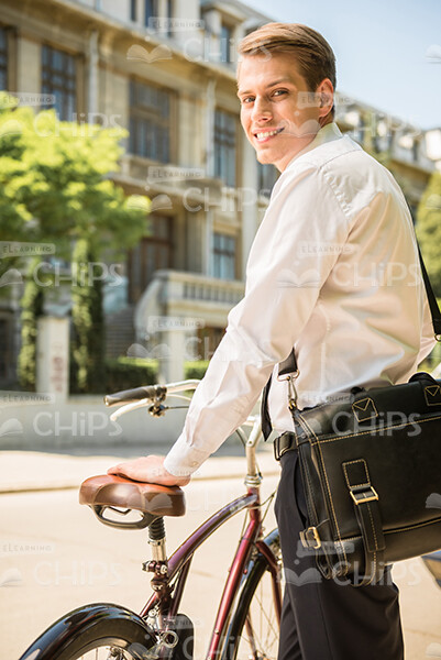 Half-Turned Young Man Going To Ride On Bicycle Stock Photo