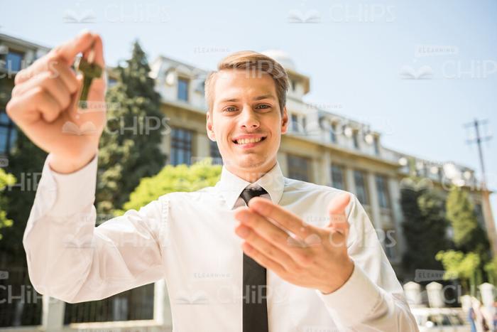 Young Man Showing Keys Stock Photo
