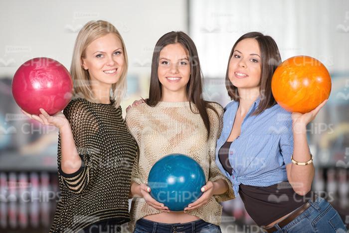 Three Pretty Girls Holding Bowling Balls Stock Photo