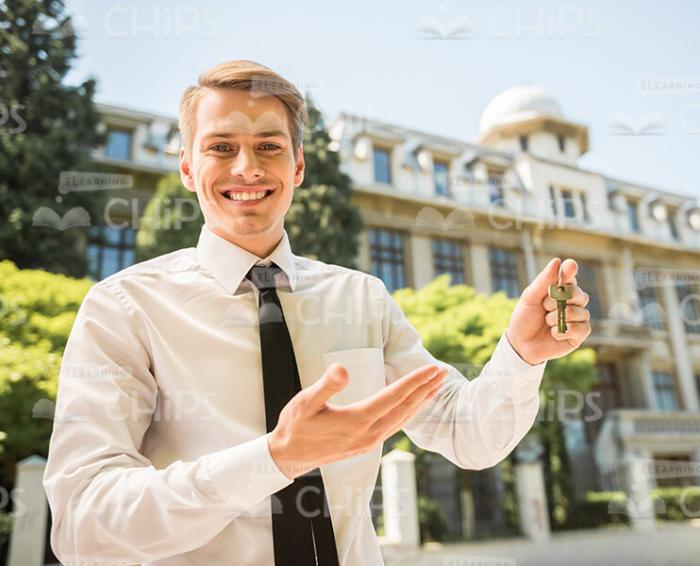 Handsome Man Presenting Keys Stock Photo