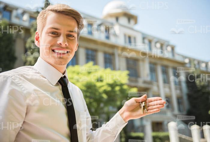 Smiling Man Holds Keys Stock Photo