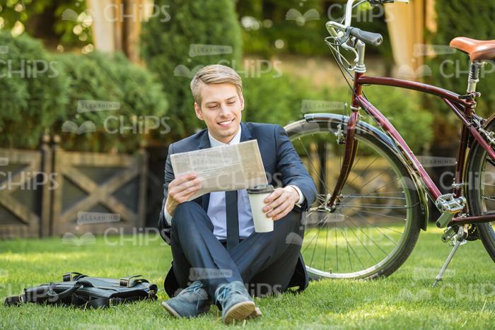 Office Worker Resting On Grass Stock Photo