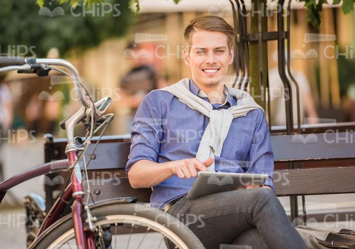 Good-Looking Man Resting And Using Tablet Stock Photo