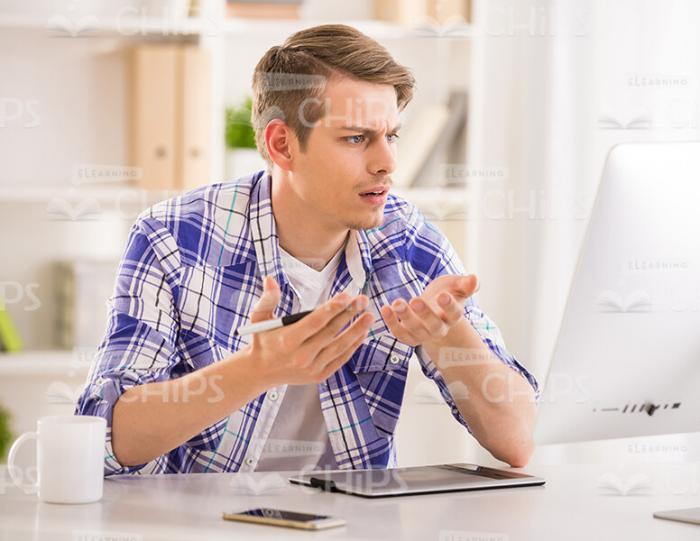 Young Student Reacts Emotionally While Working On Desktop Stock Photo
