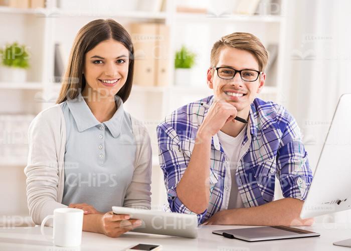 Two Attractive Students Sitting Behind The Table Stock Photo