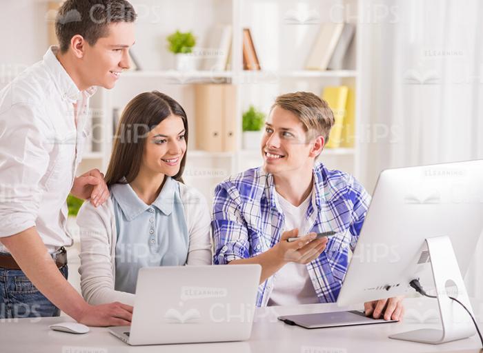 Two Students Talk With Teacher Stock Photo