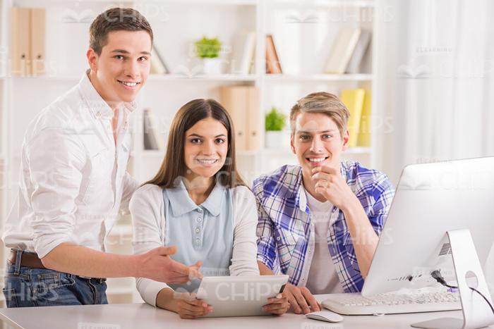 Three Happy Students Working With Tablet Stock Photo