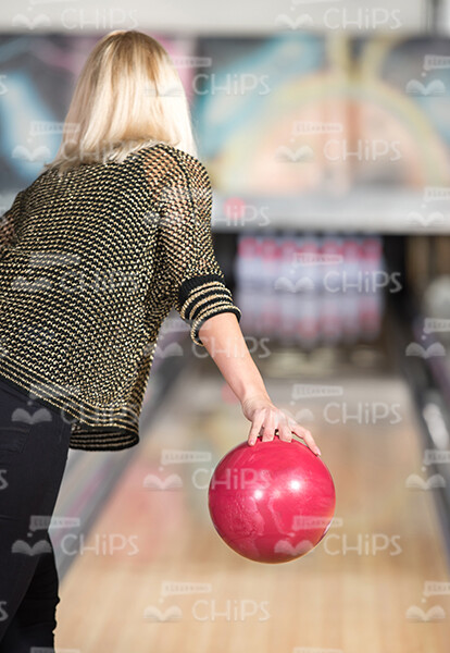 Young Woman Throwing Bowling Ball Stock Photo