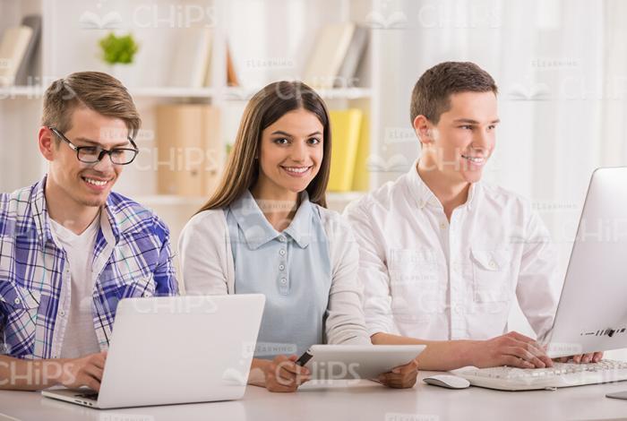 Three Young People Work With e-Devices Stock Photo