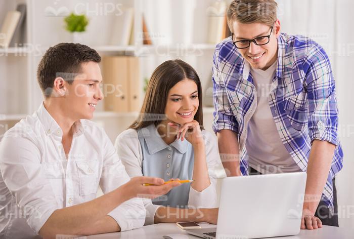 Young Man Showing Something On Laptop Stock Photo