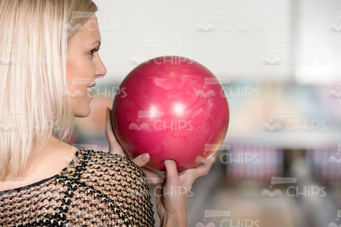 Blonde Woman Concentrates Before Throwing The Bowling Ball Stock Photo