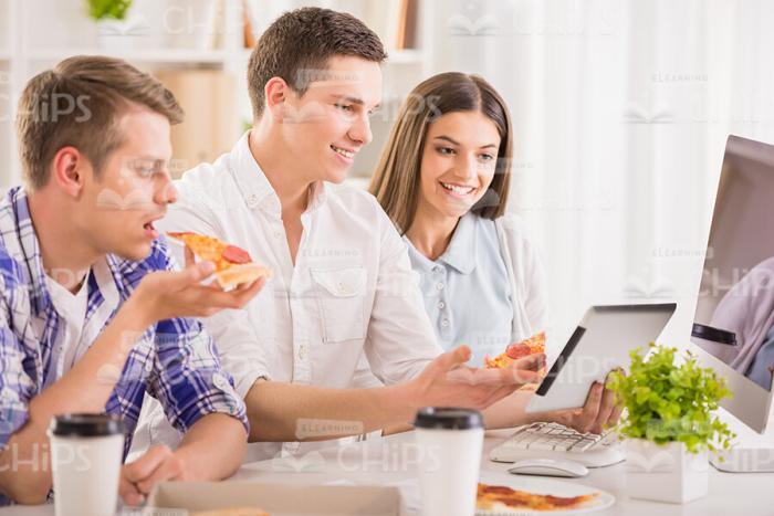 People Eating Pizza For Lunch Stock Photo