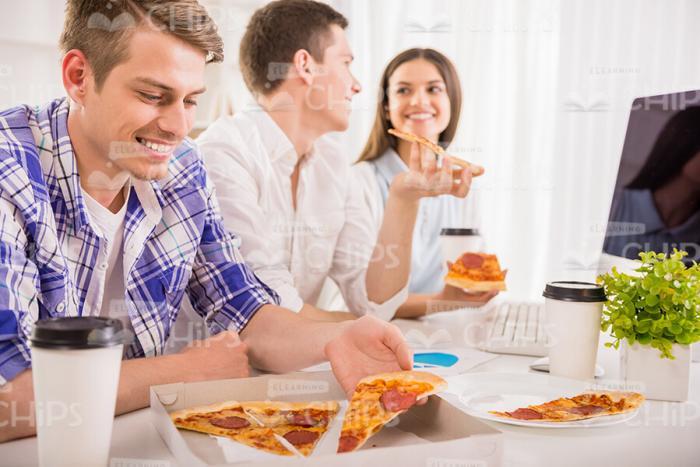 Young Students Eating Pizza Stock Photo