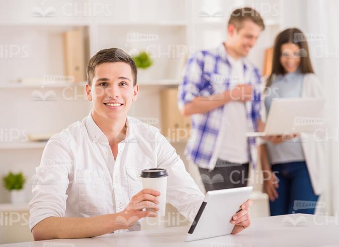 Young Man With Tablet And Coffee Cup Stock Photo